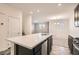 Modern kitchen with island, dark cabinetry, and stainless steel appliances at 762 Star Estates Ave, North Las Vegas, NV 89086