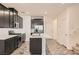 The kitchen features stainless steel appliances, island with sink and dark cabinetry at 762 Star Estates Ave, North Las Vegas, NV 89086