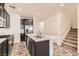 Well-appointed kitchen featuring a central island with quartz countertops, stainless steel appliances, and dark cabinetry at 762 Star Estates Ave, North Las Vegas, NV 89086