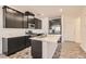 Modern kitchen featuring dark cabinetry, stainless steel appliances, and a central island with quartz countertops at 762 Star Estates Ave, North Las Vegas, NV 89086