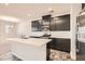 Modern kitchen with stainless steel appliances, dark cabinetry, a central island with quartz countertops, and stylish flooring at 762 Star Estates Ave, North Las Vegas, NV 89086
