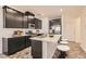 Well-equipped kitchen featuring sleek dark cabinets, stainless steel appliances, and a central island with seating at 762 Star Estates Ave, North Las Vegas, NV 89086
