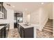 Modern kitchen with an island, dark cabinetry and stainless steel appliances at 762 Star Estates Ave, North Las Vegas, NV 89086