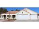 Single-story house with a three-car garage,desert landscaping, and Spanish-style tile roof at 7712 Wedlock Ln, Las Vegas, NV 89129