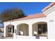 View of the house's entrance with arched entryways, terracotta tile roof and stucco walls at 7712 Wedlock Ln, Las Vegas, NV 89129