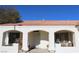 Front view of the house, showing the entrance with arched entryways and terracotta tile roof at 7712 Wedlock Ln, Las Vegas, NV 89129