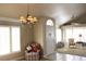 Living room with large windows, comfortable seating and chandelier at 7712 Wedlock Ln, Las Vegas, NV 89129