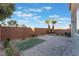 Landscaped backyard with artificial turf and a brick patio area at 8284 Arden Ladder Pl, Las Vegas, NV 89117