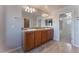 Double vanity bathroom with light wood cabinets and large mirror at 8284 Arden Ladder Pl, Las Vegas, NV 89117