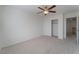 Bright bedroom with ceiling fan, large closet, and neutral carpeting at 8284 Arden Ladder Pl, Las Vegas, NV 89117