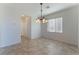 Bright dining room with tile flooring and a modern chandelier at 8284 Arden Ladder Pl, Las Vegas, NV 89117