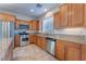 Kitchen with wood cabinets, granite counters, and stainless steel appliances at 8284 Arden Ladder Pl, Las Vegas, NV 89117