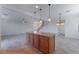 Kitchen island with granite countertop and wood cabinets at 8284 Arden Ladder Pl, Las Vegas, NV 89117