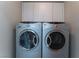 Laundry room with side-by-side washer and dryer and overhead cabinets at 8284 Arden Ladder Pl, Las Vegas, NV 89117