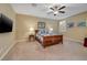 Cozy bedroom with ceiling fan and wall-mounted TV at 844 Via Serenelia, Henderson, NV 89011