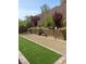 Landscaped backyard with artificial turf and desert landscaping at 889 Ariel Heights Ave, Las Vegas, NV 89138