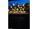 Landscaped backyard with retaining wall and lighting at night at 889 Ariel Heights Ave, Las Vegas, NV 89138