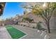 Landscaped backyard with artificial turf and retaining walls at 889 Ariel Heights Ave, Las Vegas, NV 89138