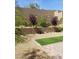 Landscaped backyard with artificial turf and retaining walls at 889 Ariel Heights Ave, Las Vegas, NV 89138