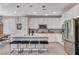 Modern kitchen with white cabinets, stainless steel appliances, and a large island at 889 Ariel Heights Ave, Las Vegas, NV 89138