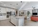 Modern kitchen with white cabinets, large island, and stainless steel appliances at 889 Ariel Heights Ave, Las Vegas, NV 89138