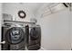 Convenient laundry room with washer and dryer, and overhead shelving at 889 Ariel Heights Ave, Las Vegas, NV 89138