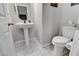 Stylish powder room with pedestal sink and patterned tile floor at 889 Ariel Heights Ave, Las Vegas, NV 89138