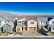 Two-story house with attached garage; neighborhood view at 9008 Rolling Pietra St, Las Vegas, NV 89166