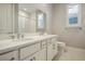 Double vanity bathroom with a toilet and window at 9008 Rolling Pietra St, Las Vegas, NV 89166