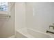 Clean bathroom with a bathtub and window at 9008 Rolling Pietra St, Las Vegas, NV 89166