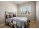 Cozy bedroom with light wood floors and a comfortable bed at 9008 Rolling Pietra St, Las Vegas, NV 89166