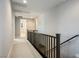 Upstairs hallway with carpeted floors and a modern railing at 9008 Rolling Pietra St, Las Vegas, NV 89166