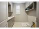 Laundry room with gray cabinets and a drain at 9008 Rolling Pietra St, Las Vegas, NV 89166