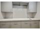 Laundry room with gray cabinets and countertop at 9008 Rolling Pietra St, Las Vegas, NV 89166