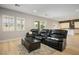 Spacious living room featuring a plush leather sectional sofa and a modern coffee table at 9008 Rolling Pietra St, Las Vegas, NV 89166