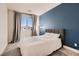 Serene bedroom with gray accent wall and window view at 9181 Theodore Ct, Las Vegas, NV 89178