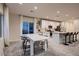 Modern dining area with white table and chairs near kitchen at 9181 Theodore Ct, Las Vegas, NV 89178