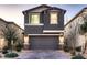 Two-story home with gray exterior, two-car garage, and landscaped front yard at 9181 Theodore Ct, Las Vegas, NV 89178