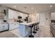 Modern kitchen island with seating and white cabinetry at 9181 Theodore Ct, Las Vegas, NV 89178