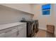 Laundry room with washer, dryer, and ample storage at 9181 Theodore Ct, Las Vegas, NV 89178