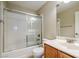 Bathroom with shower/tub combo, wood vanity, and a mirror at 9494 Stillwater Bend Ln, Las Vegas, NV 89178