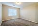 Simple bedroom with neutral walls, carpet flooring, and a window with blinds at 9494 Stillwater Bend Ln, Las Vegas, NV 89178