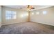 Bright bedroom featuring a ceiling fan and large windows at 9494 Stillwater Bend Ln, Las Vegas, NV 89178