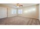 Well-lit bedroom with two windows and ceiling fan at 9494 Stillwater Bend Ln, Las Vegas, NV 89178