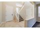 Two-story entryway with staircase and tile flooring at 9494 Stillwater Bend Ln, Las Vegas, NV 89178