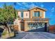 Two-story house with stone accents and a two-car garage at 9494 Stillwater Bend Ln, Las Vegas, NV 89178