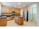 Modern kitchen featuring wood cabinets, stainless steel appliances, and an island at 9494 Stillwater Bend Ln, Las Vegas, NV 89178