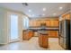 Modern kitchen with wood cabinets, stainless steel appliances and island at 9494 Stillwater Bend Ln, Las Vegas, NV 89178