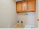 Laundry room with wood cabinets and space for washer and dryer at 9494 Stillwater Bend Ln, Las Vegas, NV 89178