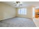 Spacious living room with neutral carpeting and ceiling fan at 9494 Stillwater Bend Ln, Las Vegas, NV 89178